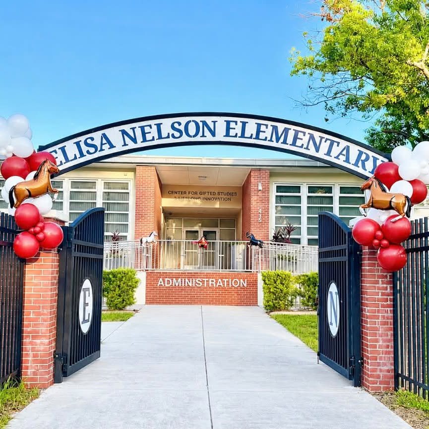 Red and white balloon columns with horse foil balloons flanking the Elisa Nelson Elementary entrance gates